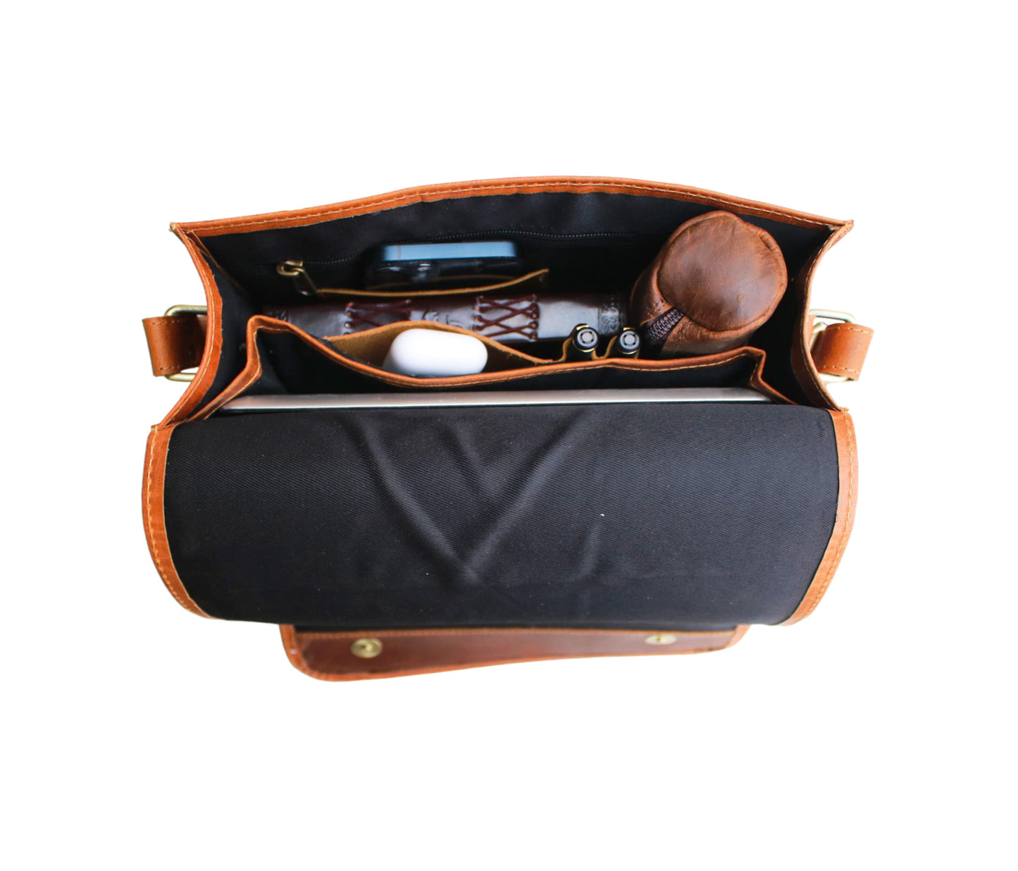 This Image Showcases The Neatly Organized Interior Of A Handcrafted Leather Messenger Bag, Highlighting Its Thoughtful Design And Functionality. Lined With Durable Black Fabric, It Features Multiple Compartments To Hold Essentials Like Journal, Smartphone, Eyeglass Case, Pens, Tech Accessories. Rich Tan Structured Silhouette, Piece Makes Stylish Personalized Customized Gift For Men Women—ideal As Birthday Gift, Graduation Or Everyday Elegant Companion.