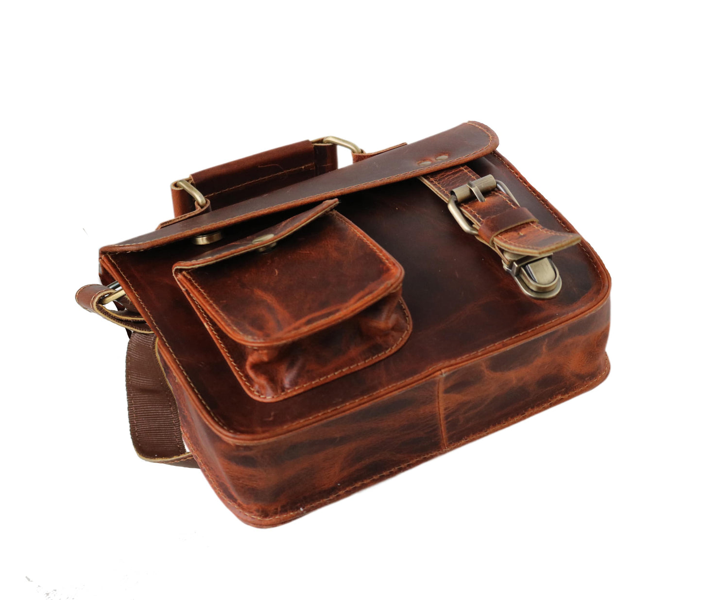 This Image Presents A Low-angle View Of Compact Leather Messenger Bag, Emphasizing Its Solid Structure And Rich Craftsmanship. Made From 100% Genuine Buffalo Leather, It Features Deep Tan Color With Natural Texture For Rustic, Timeless Look. The Front Includes Utility Pocket Snap-button Flap—perfect Keys Or Earphones. Main Flap Secures Brass Buckle Concealed Push-lock. Customized, Personalized Gift Men Women—ideal Birthdays Graduations.