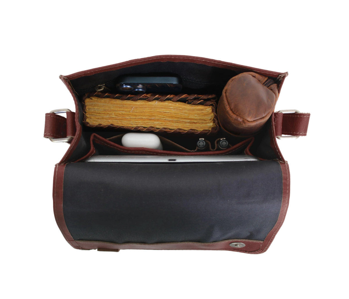 This handcrafted buffalo leather satchel blends rustic charm with everyday functionality, making it a perfect personalized gift for men and women. Designed with a sturdy top handle, quick-access front pocket, and adjustable strap, it’s ideal for carrying gadgets, journals, and daily essentials. The vintage-distressed finish adds timeless appeal. A thoughtful graduation or birthday gift, this customized vertical crossbody bag offers durability, style, and practicality for work, travel, or study.