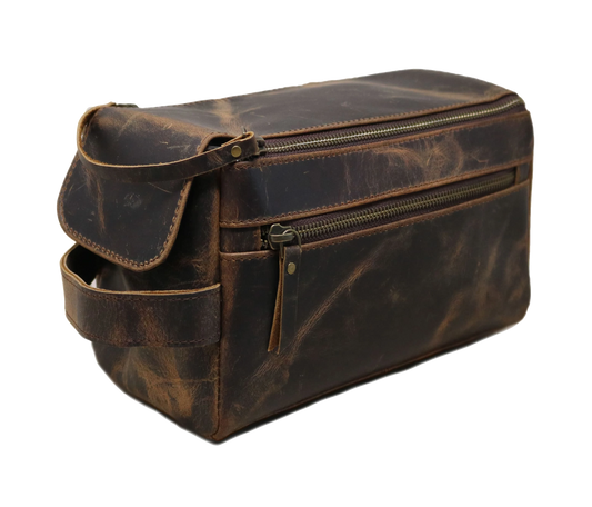 This brown leather toiletry bag features a smooth zipper closure and a detachable strap for versatile carrying. Handcrafted from premium genuine leather, it’s perfect for storing grooming essentials, shaving gear, and travel toiletries. Compact yet spacious, it fits easily into luggage or backpacks. Ideal for business trips or vacations, it makes a thoughtful personalized birthday gift, graduation gift, or customized gift for men and women who appreciate classic style and function.