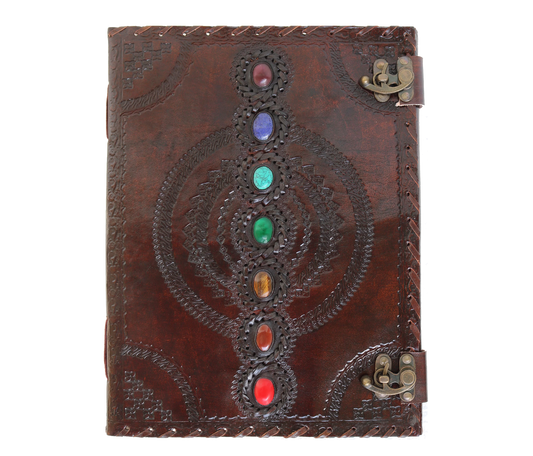 This image features a beautifully handcrafted leather chakra journal adorned with seven vibrant gemstones, each symbolizing a chakra. Intricate hand-embossed patterns and dual antiquated metal clasps add mystical, vintage charm. Ideal as a personalized spiritual diary, yoga journal, meditation log, or customized Wiccan grimoire, it blends healing energy with artisan craftsmanship. A rich brown finish and gemstone inlay make it both functional and decorative—a perfect birthday or graduation gift for men  